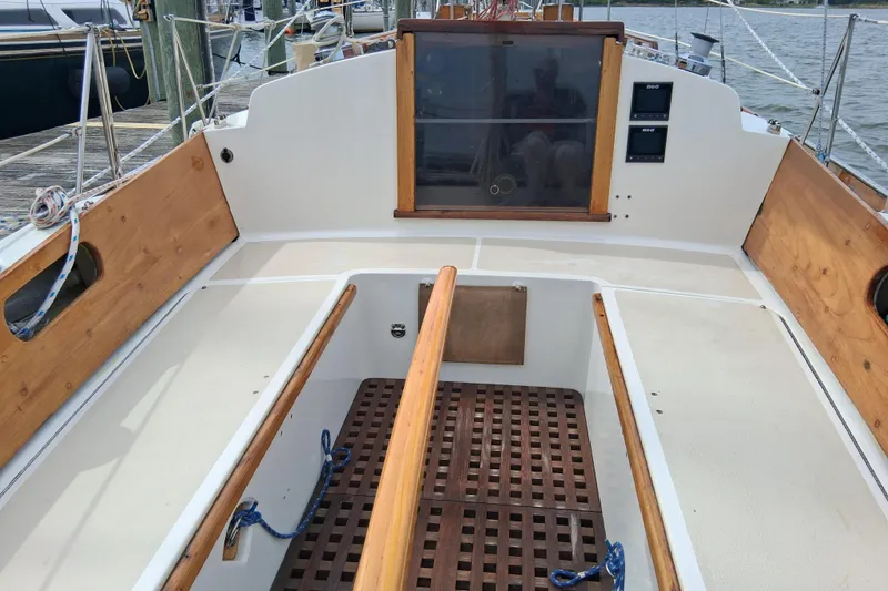 Slide: The Image of 1967 Hinckley Pilot 35 sailboat cockpit with wooden accents and nautical ropes. - 9