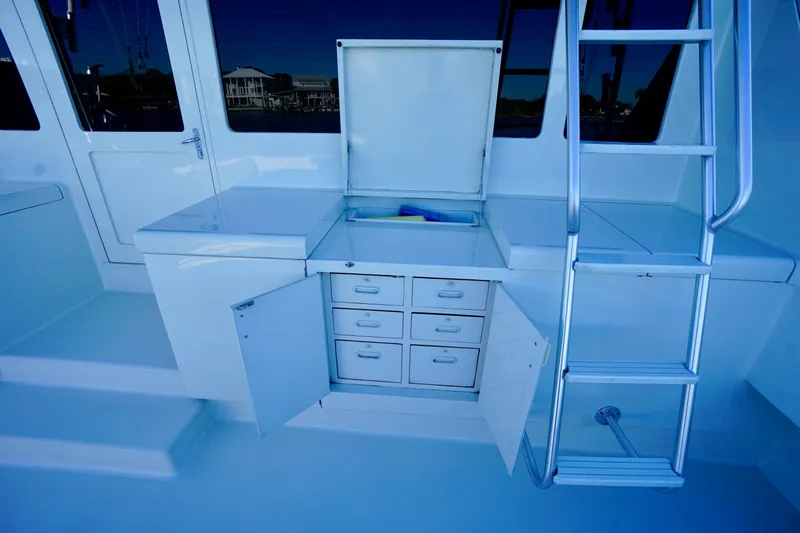 Slide: The Image of 1991 G&S 58 yacht interior with storage drawers and ladder. - 14