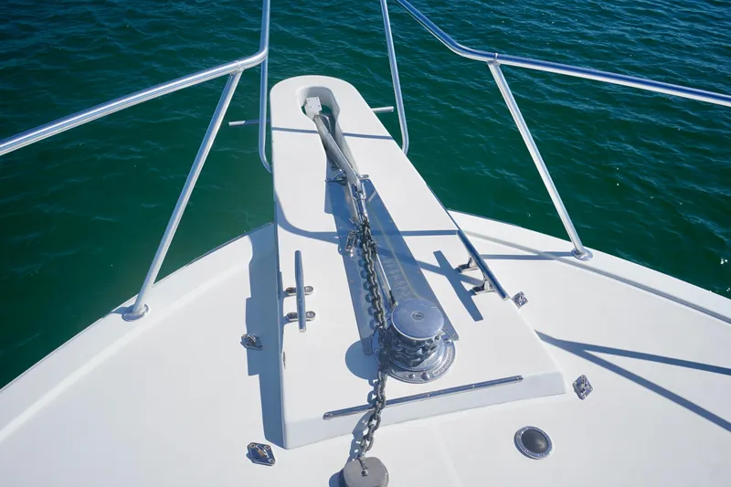 Slide: The Image of Bow of 1991 G&S 58 boat with anchor chain and railing over blue water. - 18