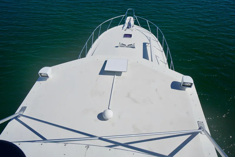 Slide: The Image of Bow view of 1991 G&S 58 yacht on calm green water. - 21