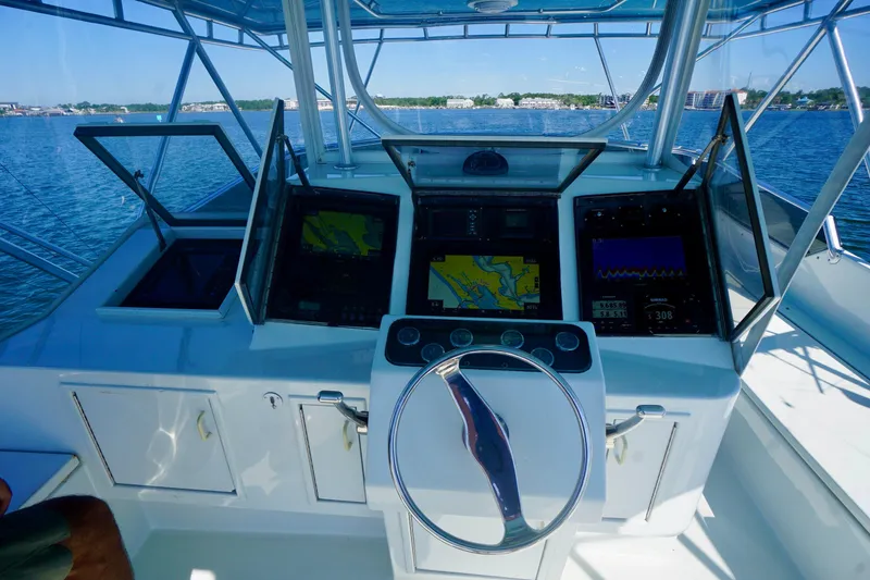 Slide: The Image of Cockpit of a 1991 G&S 58 boat with navigation screens and steering wheel. - 23