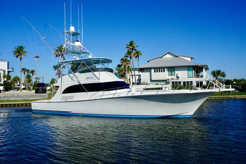 Slide: The Image of Luxury 1991 G&S 58 yacht docked near waterfront home, clear blue sky. - 3