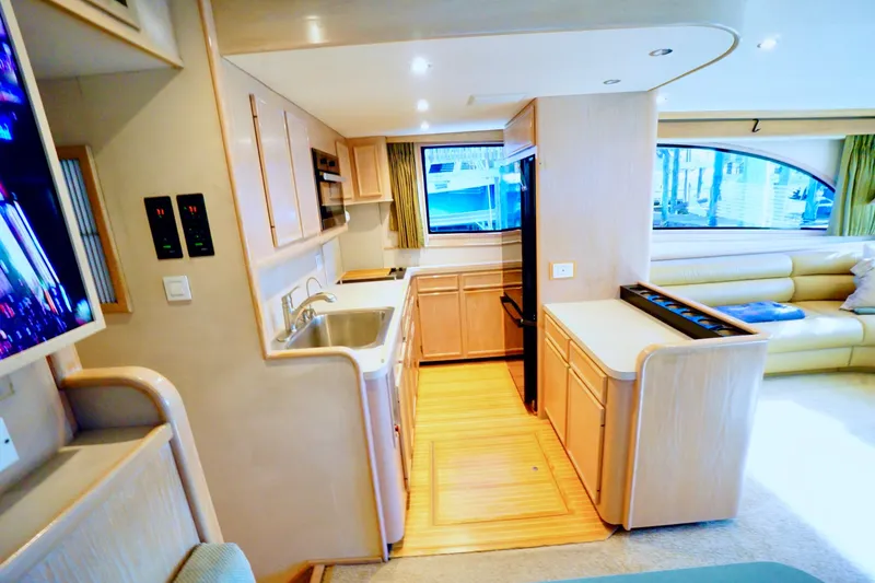 Slide: The Image of Interior of a 1991 G&S 58 yacht featuring a modern kitchen and cozy seating area. - 31