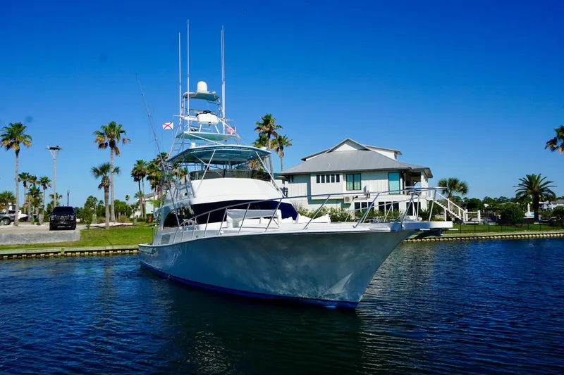 Slide: The Image of Luxury G&S 58 yacht from 1991 docked near a waterfront house. - 4