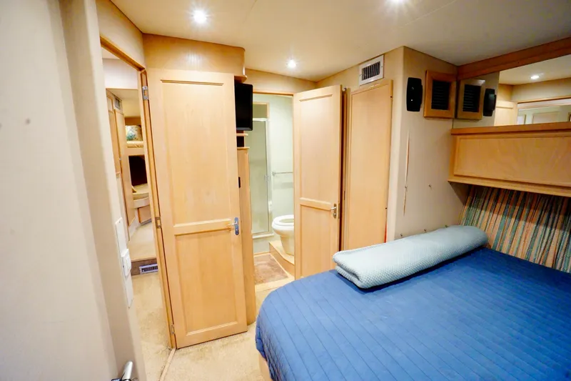 Slide: The Image of Cozy bedroom with blue bedding in 1991 G&S model 58 yacht interior. - 41