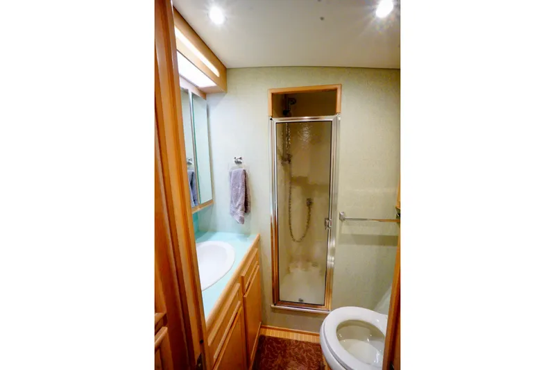 Slide: The Image of Compact bathroom with shower, sink, and toilet in a 1991 G&S 58 model. - 43