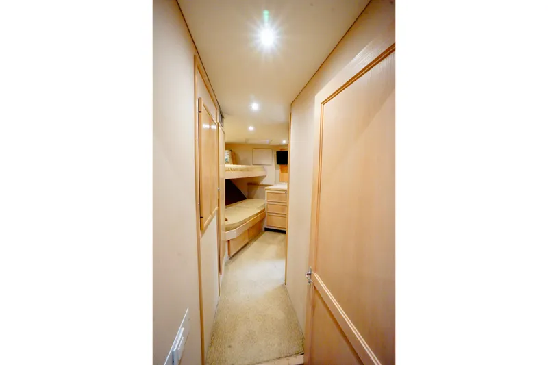 Slide: The Image of Interior of 1991 G&S 58 yacht, featuring cozy bunk beds and wooden cabinetry. - 46