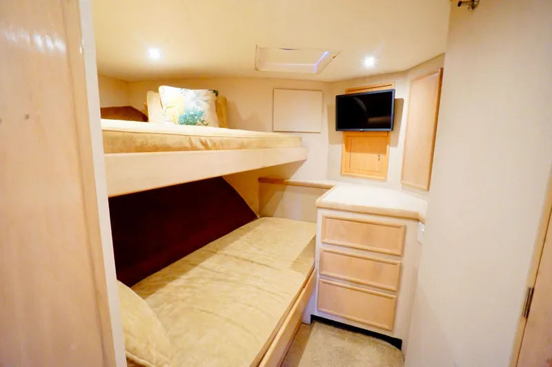 Slide: The Image of Cozy cabin interior with bunk beds, TV, and storage in a 1991 G&S 58 model. - 52