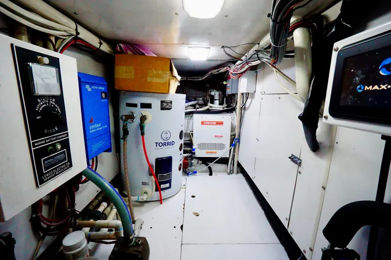 Slide: The Image of Engine room of a 1991 G&S 58 yacht with equipment and wiring. - 54