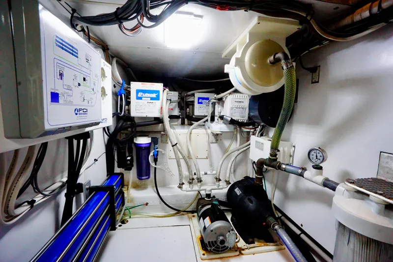 Slide: The Image of Engine room of a 1991 G&S 58 boat with various mechanical equipment and piping. - 55