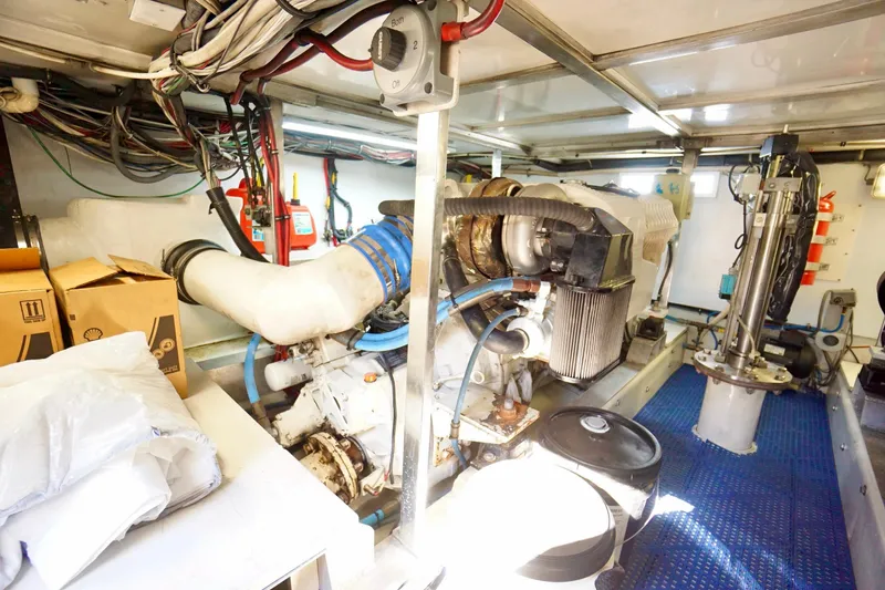 Slide: The Image of Engine room of a 1991 G&S 58 boat, featuring complex machinery and wiring. - 57
