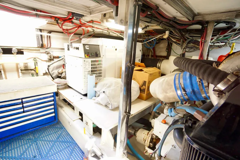 Slide: The Image of Engine room of a 1991 G&S 58 boat with equipment and wiring. - 58