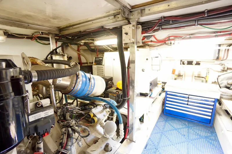 Slide: The Image of Engine room of a 1991 G&S 58 boat with visible machinery and tool storage. - 59