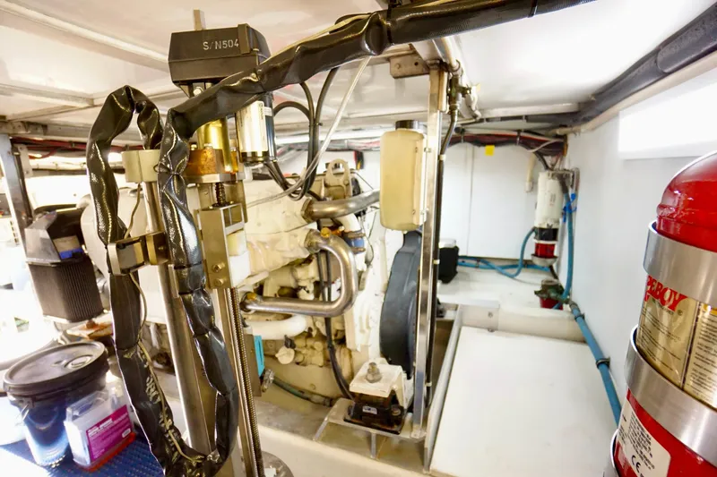 Slide: The Image of Engine room of a 1991 G&S 58 boat, featuring mechanical components and fire extinguisher. - 61