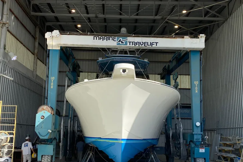 Slide: The Image of A 1991 G&S 58 boat in a Marine Travelift facility for maintenance. - 64