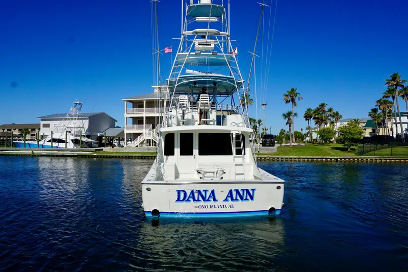 Slide: The Image of G&S 58 yacht "Dana Ann" from 1991 docked near palm trees and waterfront homes. - 8