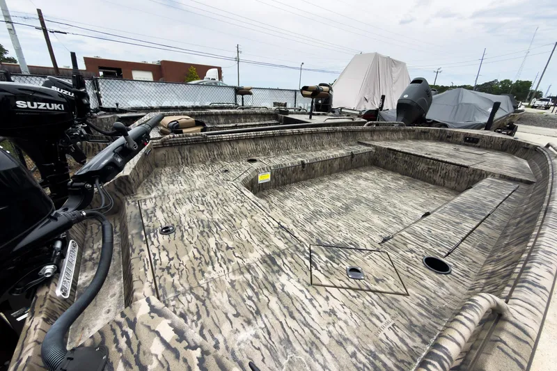 Slide: The Image of 2026 Excel 183 Tomahawk boat with camouflage design and Suzuki motor in outdoor setting. - 3
