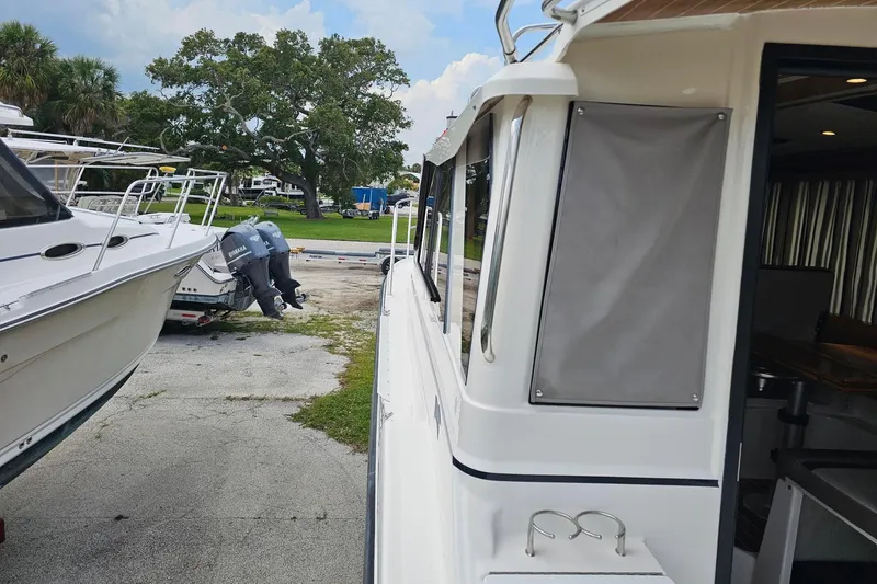 Slide: The Image of 2021 Cutwater C-28 boat docked, showcasing sleek design and outdoor setting. - 10