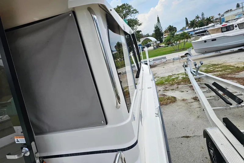 Slide: The Image of 2021 Cutwater C-28 boat beside trailer in marina setting. - 11