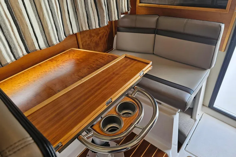 Slide: The Image of Interior of 2021 Cutwater C-28 boat with wooden table and cushioned seating. - 16