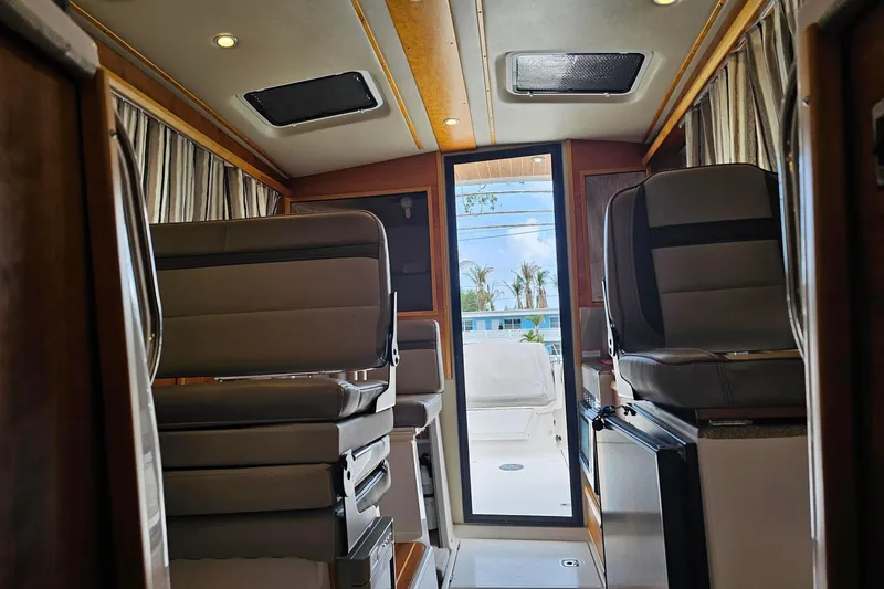 Slide: The Image of Interior of a 2021 Cutwater C-28 boat, featuring modern seating and natural light. - 18