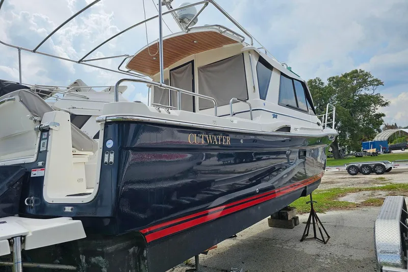 Slide: The Image of 2021 Cutwater C-28 boat on dry dock, showcasing sleek design and modern features. - 2