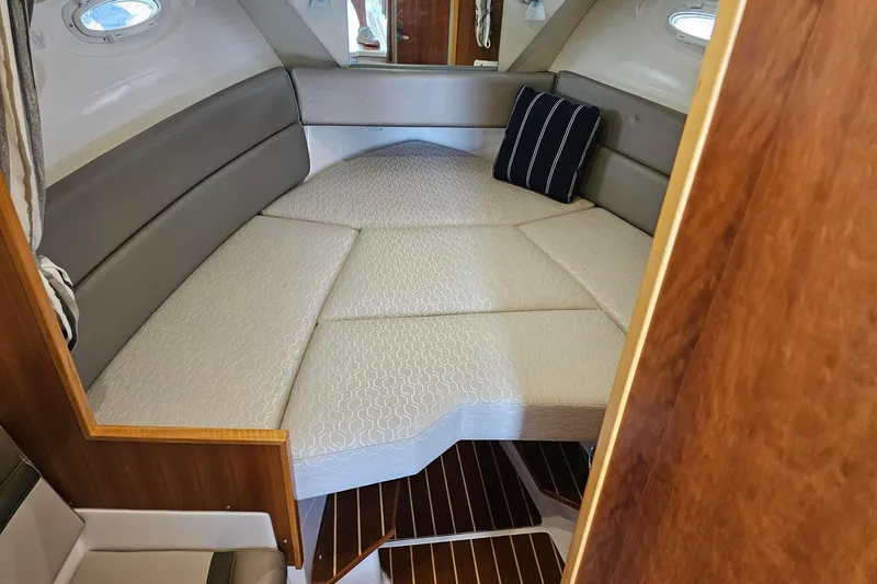 Slide: The Image of 2021 Cutwater C-28 cabin interior with cushioned seating and striped pillow. - 20