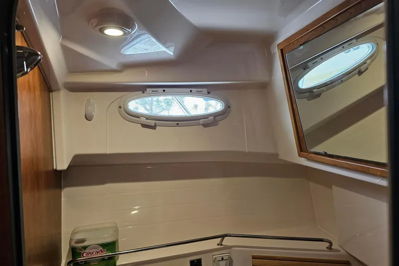 Slide: The Image of 2021 Cutwater C-28 boat interior with porthole window and mirror in bathroom. - 21
