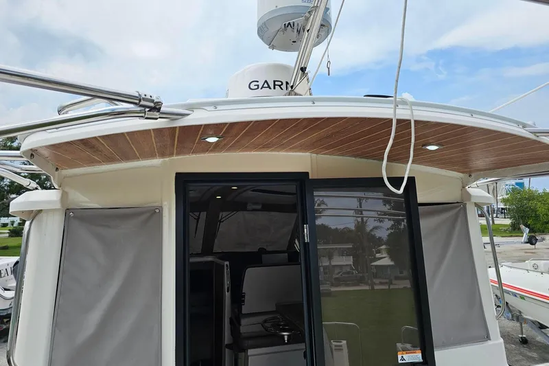 Slide: The Image of 2021 Cutwater C-28 boat with wooden ceiling and sliding glass door. - 9