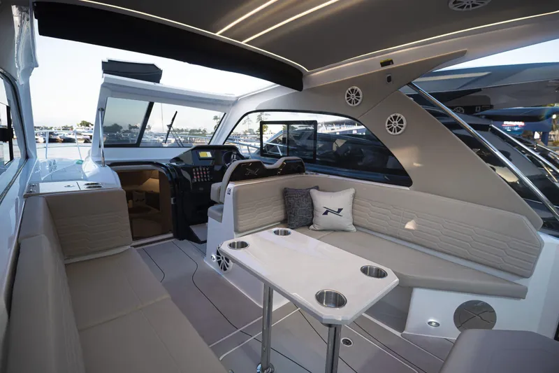 Slide: The Image of Luxurious interior of 2025 NX Boats NX350 MAXIMUS with modern seating and sleek design. - 16
