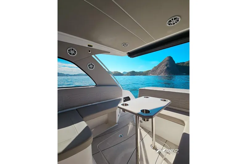 Slide: The Image of Interior of 2025 NX Boats NX350 MAXIMUS with ocean view and seating area. - 21