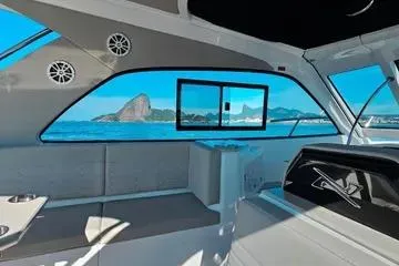 Slide: The Image of Interior of 2025 NX Boats NX350 MAXIMUS with ocean view through large windows. - 3