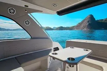 Slide: The Image of 2025 NX Boats NX350 MAXIMUS interior with ocean view and scenic mountains. - 4