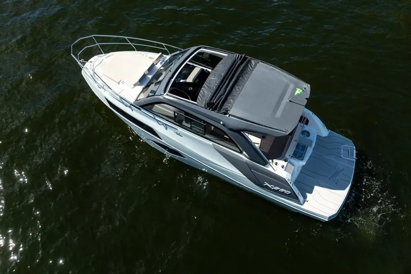 Slide: The Image of 2025 NX Boats NX350 MAXIMUS cruising on water, aerial view. - 8