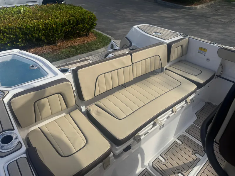 Slide: The Image of 2023 Yamaha Boats 255 FSH Sport E interior with beige seating and deck. - 22