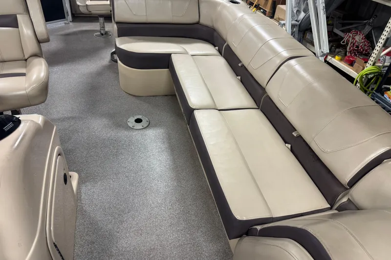 Slide: The Image of 2018 Sun Tracker Fishin' Barge 24 XP3 interior with beige seating and carpeted floor. - 10