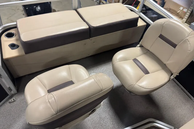 Slide: The Image of 2018 Sun Tracker Fishin' Barge 24 XP3 interior with beige seating and cup holder. - 14