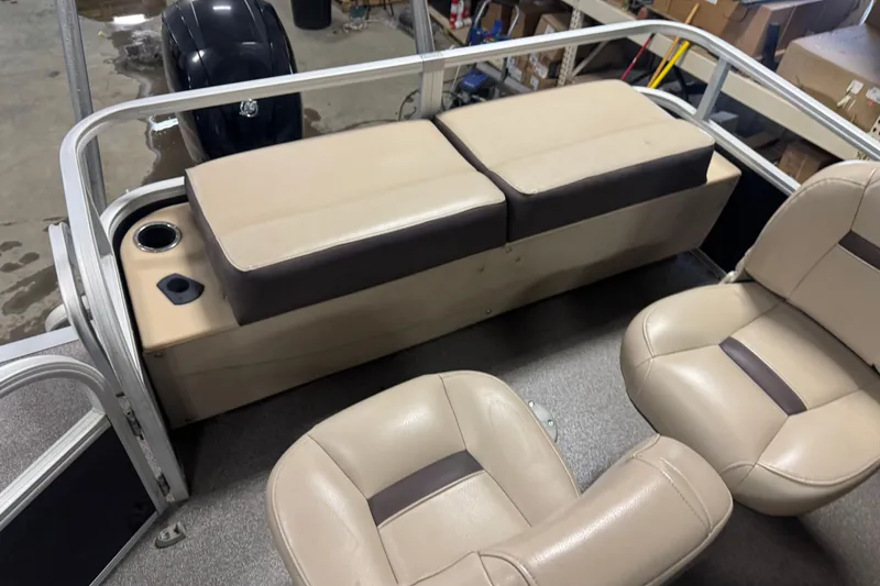 Slide: The Image of 2018 Sun Tracker Fishin' Barge 24 XP3 interior with beige seating and storage area. - 15