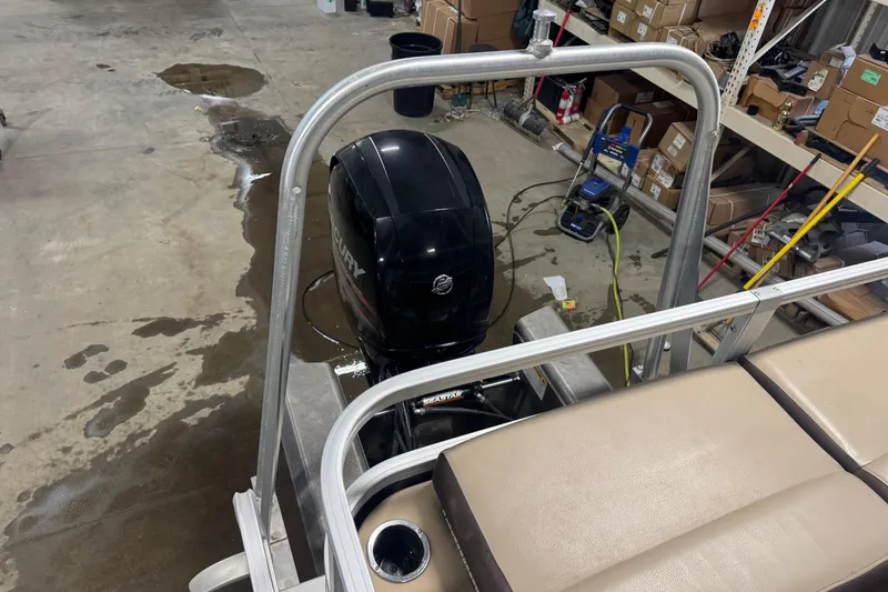 Slide: The Image of 2018 Sun Tracker Fishin' Barge 24 XP3 with Mercury outboard motor in a workshop. - 16