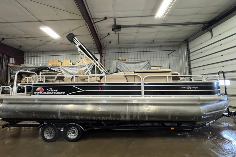 Slide: The Image of 2018 Sun Tracker Fishin' Barge 24 XP3 pontoon boat in indoor storage facility. - 3