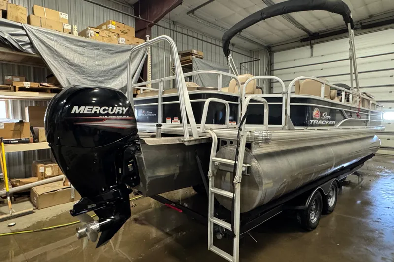 Slide: The Image of 2018 Sun Tracker Fishin' Barge 24 XP3 pontoon boat with Mercury outboard motor in a garage. - 4