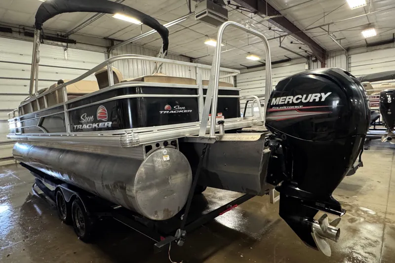 Slide: The Image of 2018 Sun Tracker Fishin' Barge 24 XP3 pontoon boat with Mercury outboard motor in a garage. - 5