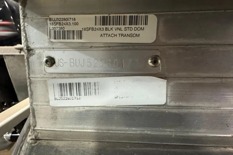 Slide: The Image of 2018 Sun Tracker Fishin' Barge 24 XP3 identification plates and barcodes on metal surface. - 6