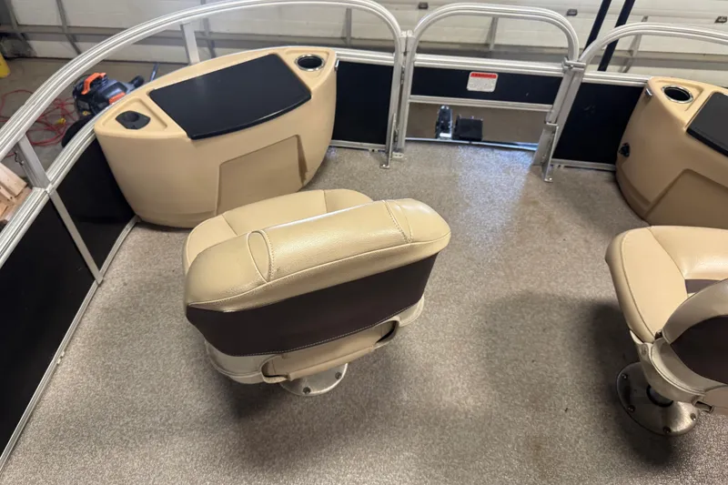 Slide: The Image of 2018 Sun Tracker Fishin' Barge 24 XP3 interior with beige seating and console. - 7