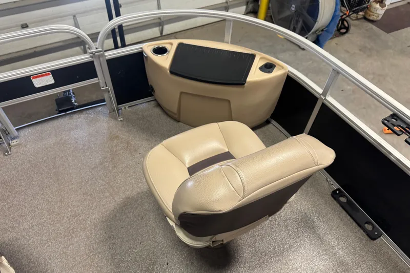 Slide: The Image of 2018 Sun Tracker Fishin' Barge 24 XP3 interior with beige seating and fishing station. - 8