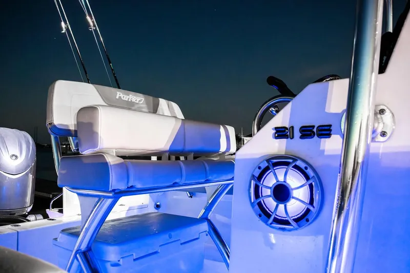 Slide: The Image of Manufacturer Provided Image: 2026 Parker 210 Coastal boat interior with illuminated seating and speaker at night. - 4