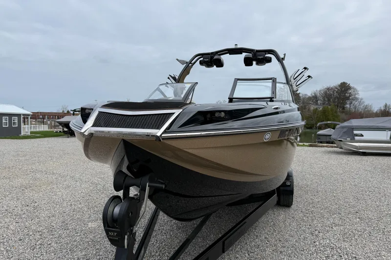 Slide: The Image of 2019 Centurion Ri257 boat on trailer, displayed outdoors on gravel surface. - 11