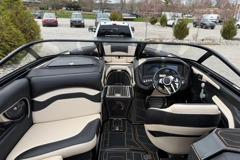 Slide: The Image of 2019 Centurion Ri257 boat interior with modern dashboard and luxurious seating. - 12