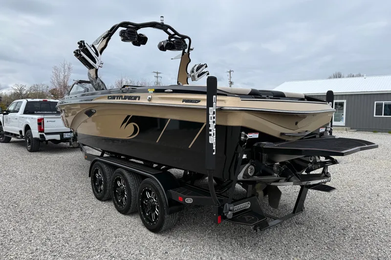 Slide: The Image of 2019 Centurion Ri257 boat on trailer, parked outdoors near a building. - 8