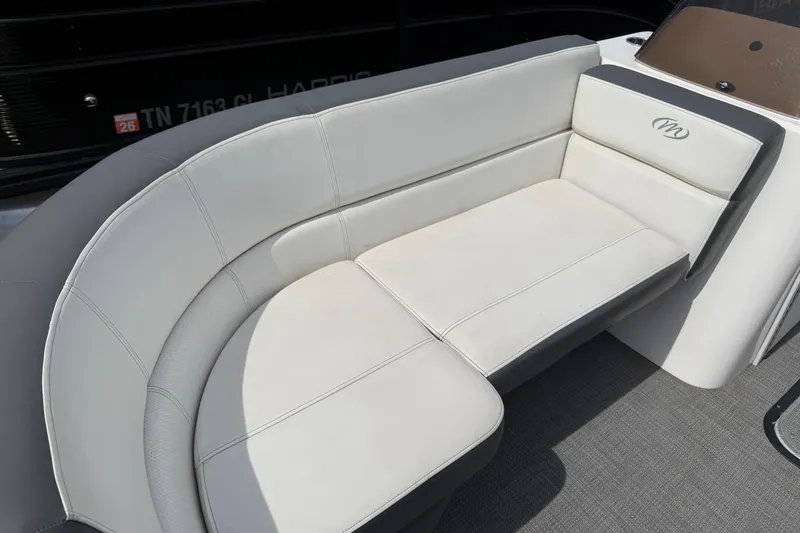 Slide: The Image of 2022 Manitou Aurora LE boat interior with white cushioned seating. - 4